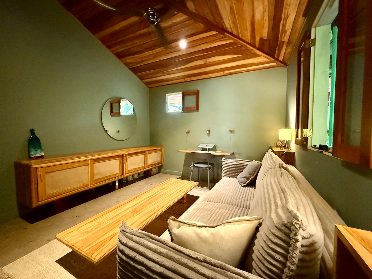 Living room from another angle showing desk and storage