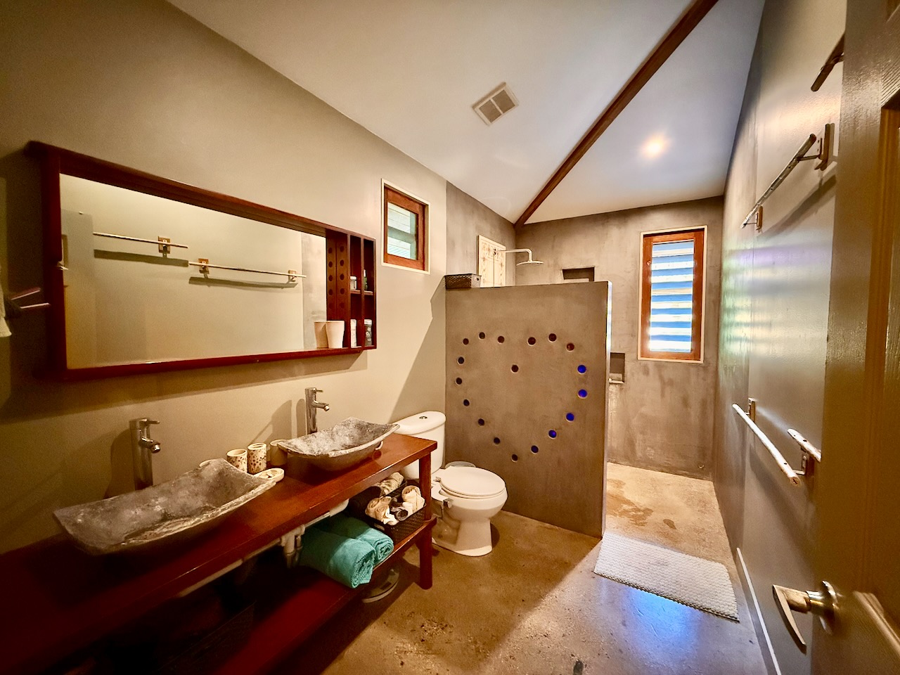 Bathroom with stone basin sinks and walk-in shower