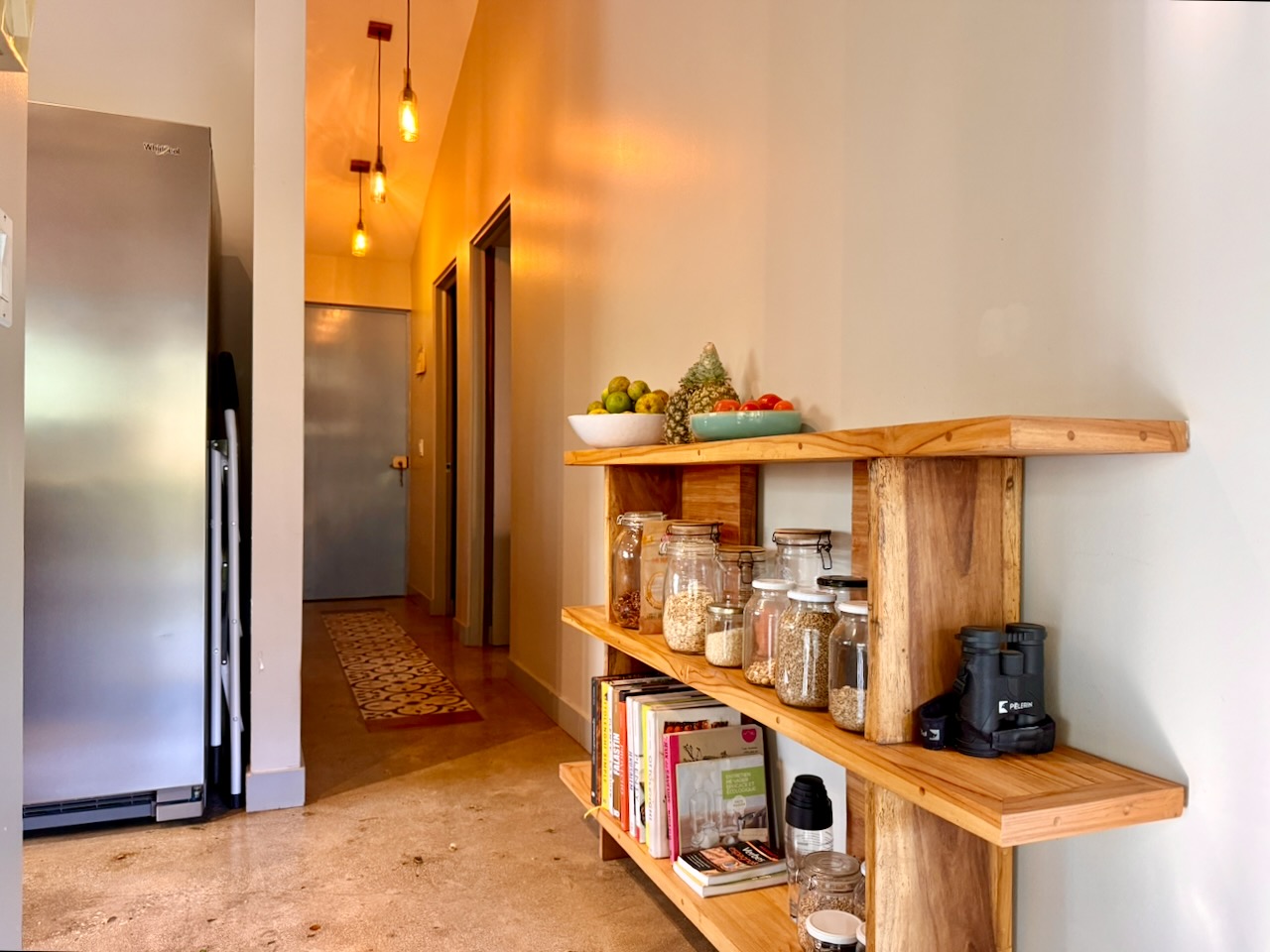 Hallway with wooden shelves and pendant lighting