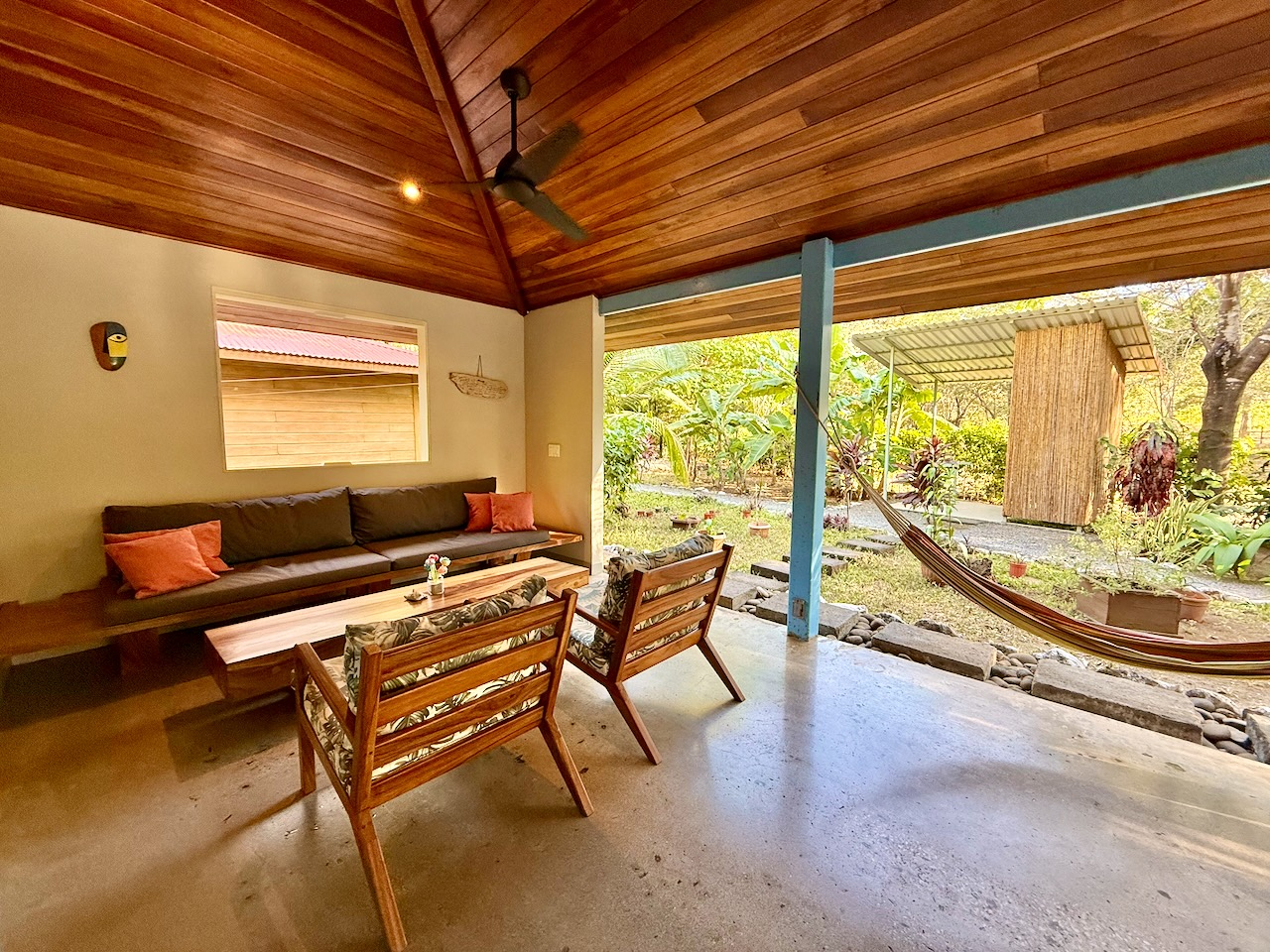 Covered outdoor lounge with garden view