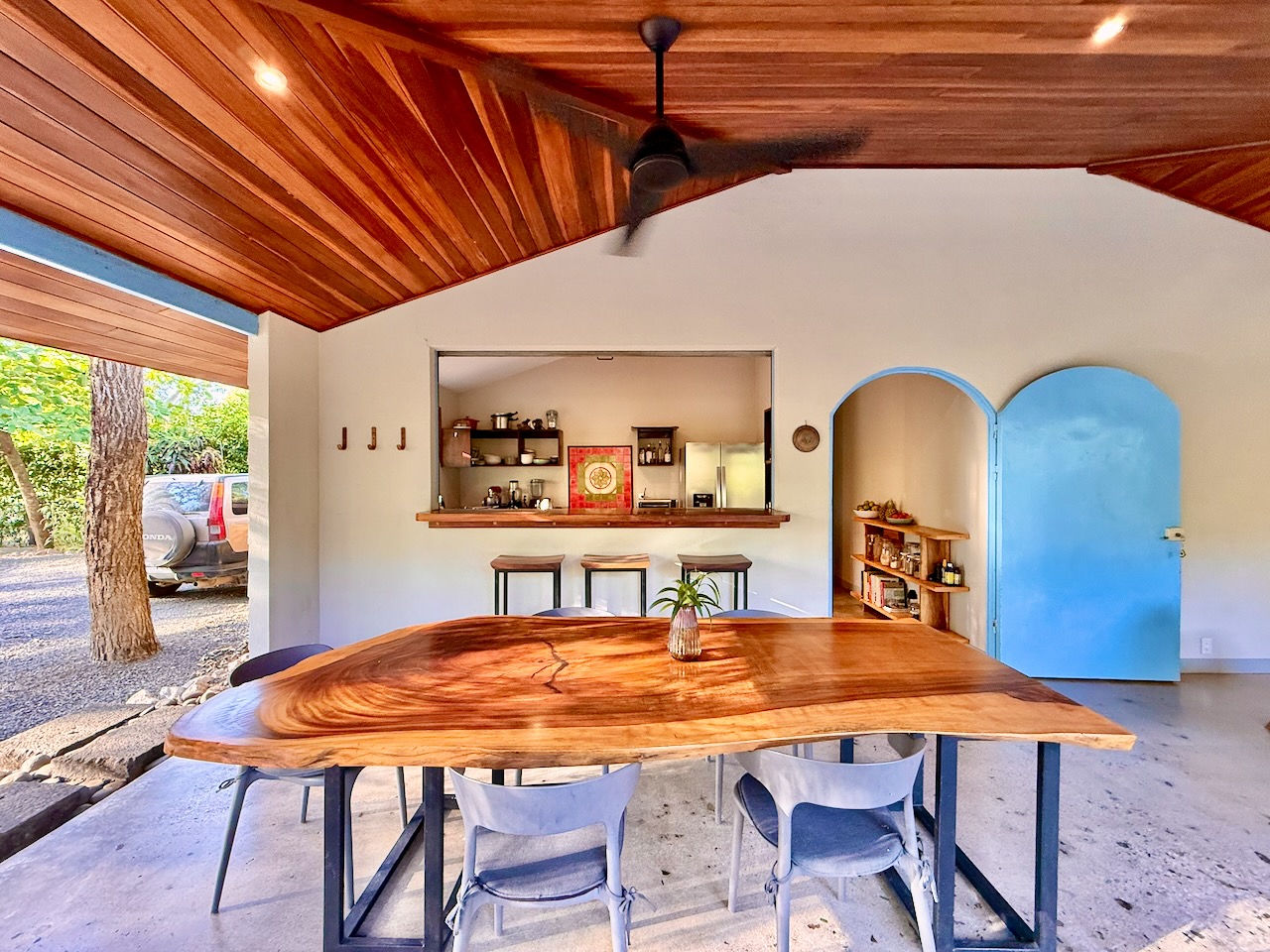 Dining table with kitchen pass-through and arched door